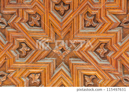 Wood carving with sacred geometric patterns. Manual labor of a woodworking master 115497631
