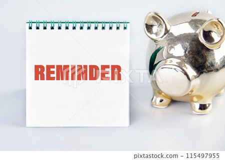 Business motivational inspirational concept. Reminder, text words on a notebook with a piggy bank next to it Business motivational inspirational concept. Reminder, text words on a notebook with a piggy bank next to it 115497955