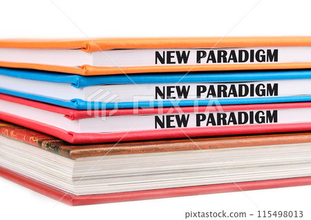 New paradigm motivational phrase on the ends of notebooks lying on top of each other on a white background New paradigm motivational phrase on the ends of notebooks lying on top of each other on a white background 115498013