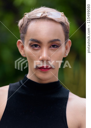 Beautiful Asian queer LGBT community supporter man with mustache wearing lipstick and jumpsuit Beautiful Asian queer LGBT community supporter man with mustache wearing lipstick and jumpsuit 115499080