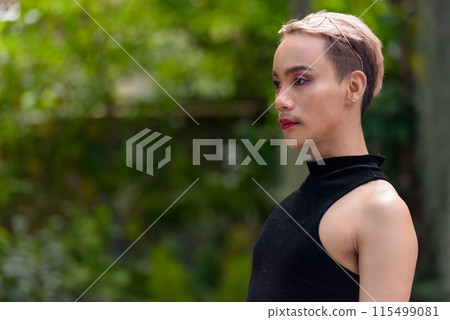 Profile view of queer LGBT community supporter man with mustache wearing lipstick and jumpsuit Profile view of queer LGBT community supporter man with mustache wearing lipstick and jumpsuit 115499081