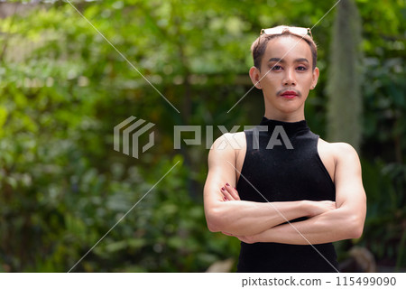 Beautiful Asian queer LGBT community supporter man with mustache wearing lipstick and jumpsuit Beautiful Asian queer LGBT community supporter man with mustache wearing lipstick and jumpsuit 115499090