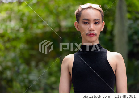 Beautiful Asian queer LGBT community supporter man with mustache wearing lipstick and jumpsuit Beautiful Asian queer LGBT community supporter man with mustache wearing lipstick and jumpsuit 115499091