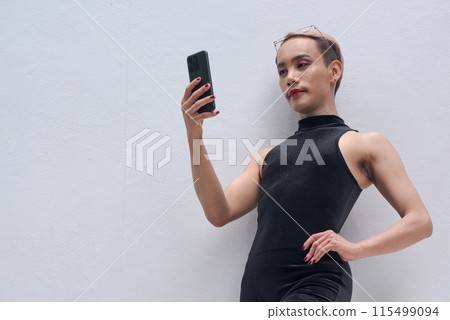 Queer LGBT community supporter man with mustache against white background using mobile phone 115499094