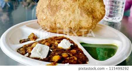 Chole bhature is a North Indian food dish. A combination of chana masala and bhatura or puri Chole bhature is a North Indian food dish. A combination of chana masala and bhatura or puri 115499292