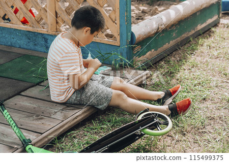 The First Bandage: A child's initiation into the world of first-aid, showing determination and care in the face of minor adversity. The First Bandage: A child's initiation into the world of first-aid, showing determination and care in the face of minor adversity. 115499375