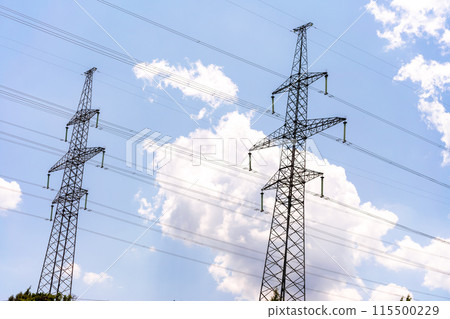 High voltage towers with sky background. Power line support with wires for electricity transmission. High voltage grid tower with wire cable at distribution station. Energy industry, energy saving 115500229