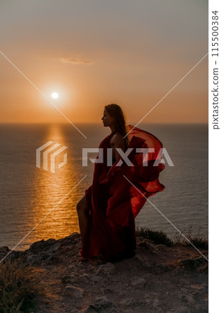 Woman sunset sea red dress, back view a happy beautiful sensual woman in a red long dress posing on a rock high above the sea on sunset. Woman sunset sea red dress, back view a happy beautiful sensual woman in a red long dress posing on a rock high above the sea on sunset. 115500384
