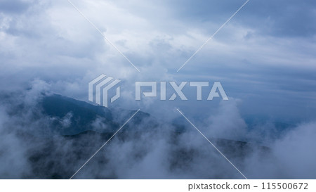 Clouds hanging over the mountain peak on a rainy day 115500672