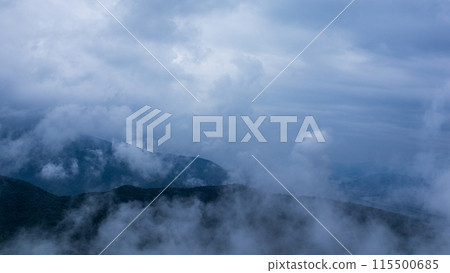 Clouds hanging over the mountain peak on a rainy day Clouds hanging over the mountain peak on a rainy day 115500685
