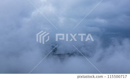 Clouds hanging over the mountain peak on a rainy day Clouds hanging over the mountain peak on a rainy day 115500717
