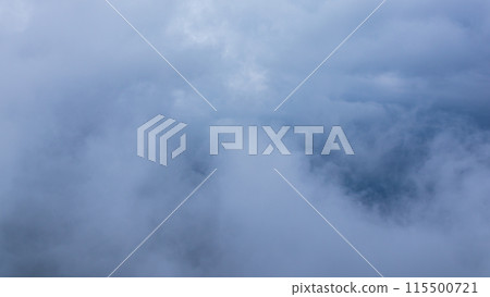 Clouds hanging over the mountain peak on a rainy day 115500721
