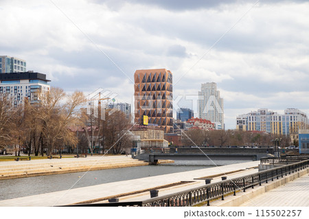city panorama from embankment. Headquarters of Russian copper company by architect Norman Foster. red brown pineapple skyscraper, bridge, Iset river. Copper House building Yekaterinburg, Russia 5.5.23 115502257