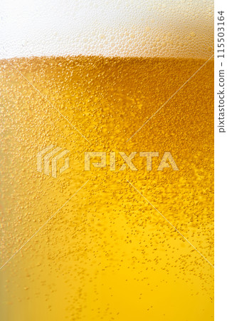 Draft beer poured into a glass, close-up Draft beer poured into a glass, close-up 115503164