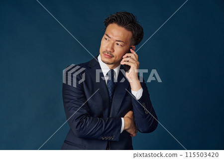 Businessman talking on a smartphone Businessman talking on a smartphone 115503420
