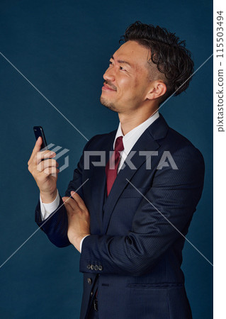 Businessman talking on a smartphone Businessman talking on a smartphone 115503494