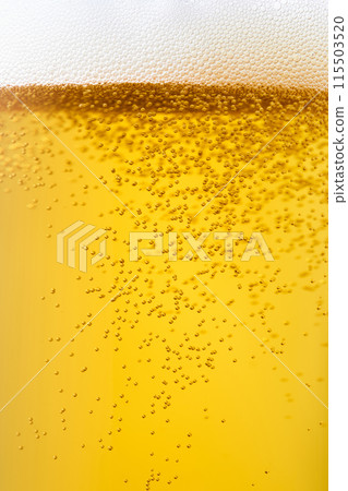 Draft beer poured into a glass, close-up 115503520