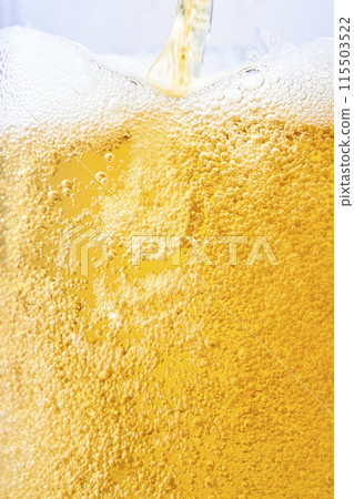 Draft beer poured into a glass, close-up Draft beer poured into a glass, close-up 115503522