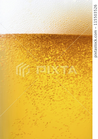 Draft beer poured into a glass, close-up 115503526
