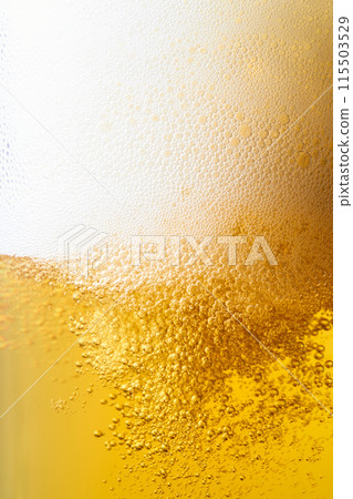 Draft beer poured into a glass, close-up 115503529