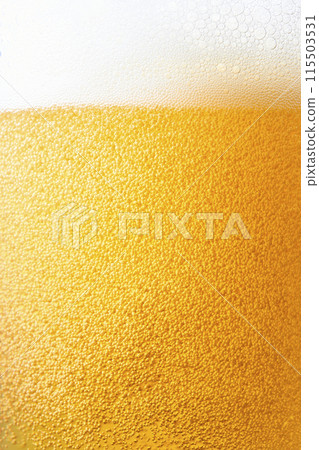 Draft beer poured into a glass, close-up 115503531