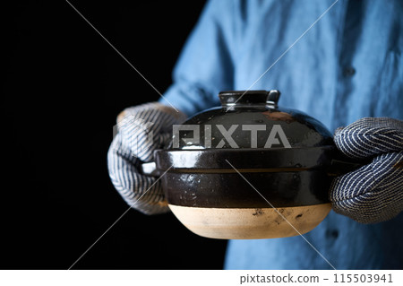 Man holding a rice cooker Man holding a rice cooker 115503941