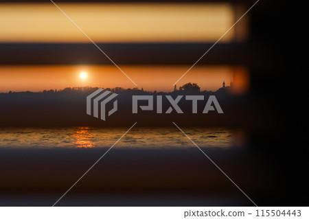 Sunset through the blinds Sunset through the blinds 115504443