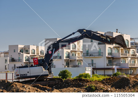 Excavator digging soil at a construction site 2 Excavator digging soil at a construction site 2 115505304