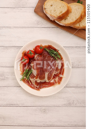 Prosciutto served on a plate 115505400
