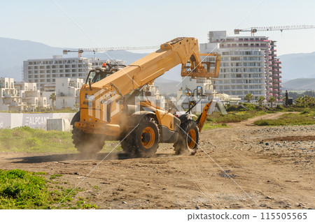 yellow front loader goes to a construction site 2 yellow front loader goes to a construction site 2 115505565