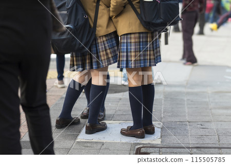 The feet of a high school girl wearing navy blue socks 115505785