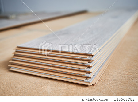 Samples of laminate timber boards with pattern and wood texture for flooring and interior design. Stack of wooden flooring planks for home renovation, construction works and interior architecture. Samples of laminate timber boards with pattern and wood texture for flooring and interior design. Stack of wooden flooring planks for home renovation, construction works and interior architecture. 115505792