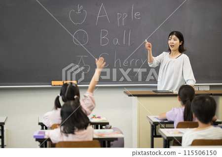 An English lesson in a Japanese elementary school classroom: teacher and children An English lesson in a Japanese elementary school classroom: teacher and children 115506150