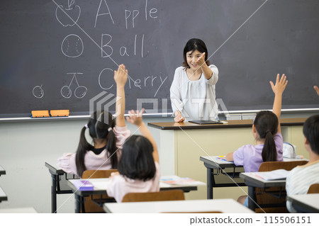 An English lesson in a Japanese elementary school classroom: teacher and children An English lesson in a Japanese elementary school classroom: teacher and children 115506151