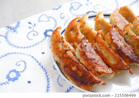 Grilled gyoza that is crispy on the outside and juicy on the inside. Grilled gyoza that is crispy on the outside and juicy on the inside. 115506499