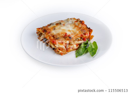 plate of lasagna with green basil on white background plate of lasagna with green basil on white background 115506513