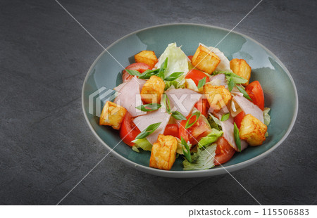 salad with ham and halloumi cheese on stone background 115506883