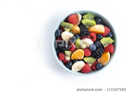Fruit salad in a blue bowl isolated on white background Fruit salad in a blue bowl isolated on white background 115507500