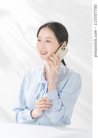 A woman making a phone call 115507780