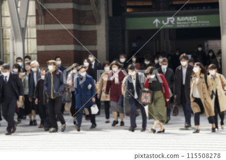 Businessmen wearing masks crossing a pedestrian crossing in a blur 115508278