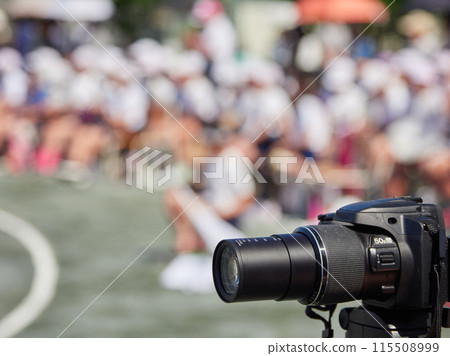 A camera taking pictures at an elementary school sports day 115508999