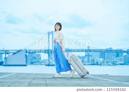 Young woman walking with suitcase 115509182