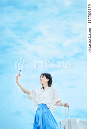 Young woman walking with suitcase 115509189