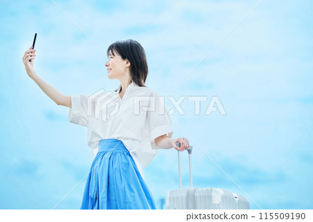 Young woman walking with suitcase 115509190