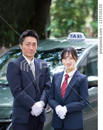Male and female taxi drivers looking at each other with a smile 115510120