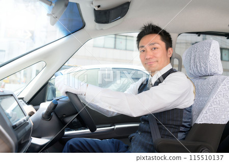 Male driver smiling from the driver's seat / taxi driver image 115510137