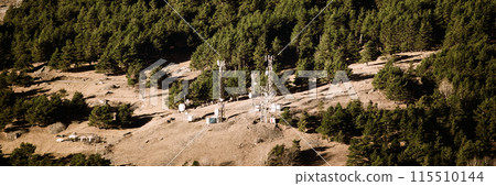 Telecommunications Cell Phone Towers With Antennas On Background Of Mountains Forest 115510144
