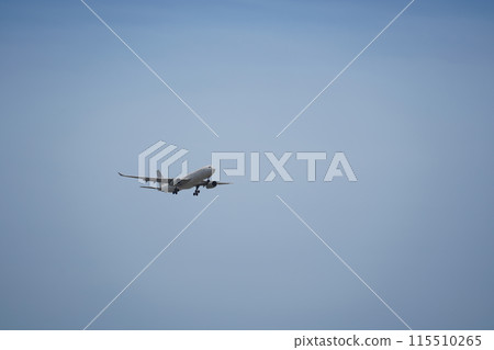 Airplane is flying in the sky with the landing gear down 115510265