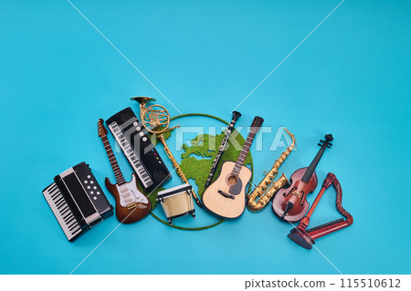 World Music Day. Assortment of Musical Instruments with world map on Blue background 115510612