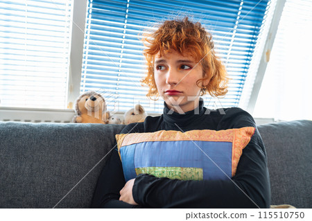portrait naked crying teenage girl, with red curly hair, sitting on sofa, hugging pillow, in fetal position portrait naked crying teenage girl, with red curly hair, sitting on sofa, hugging pillow, in fetal position 115510750